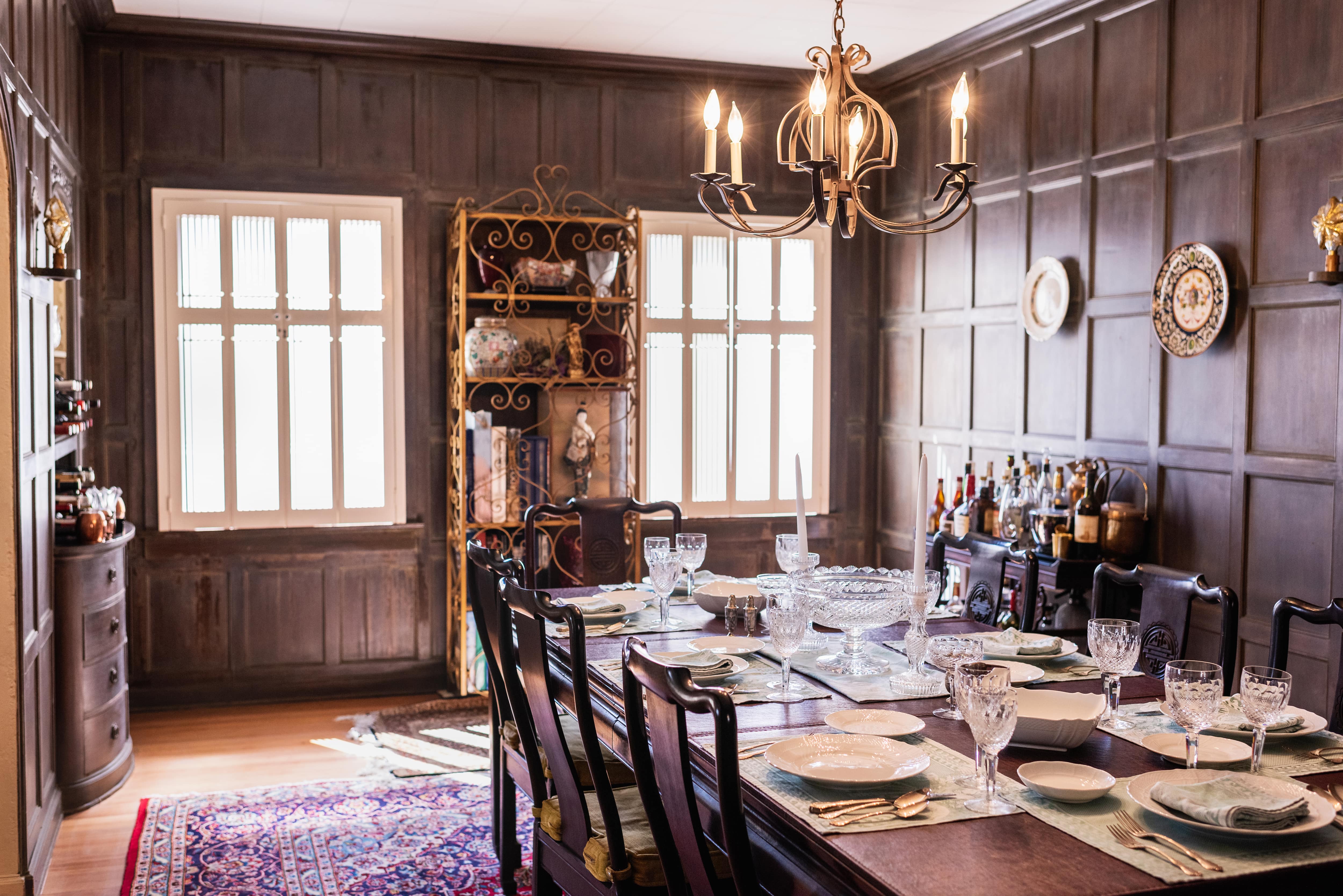 Rustic dining room with floor to ceiling dark wood wainscoting