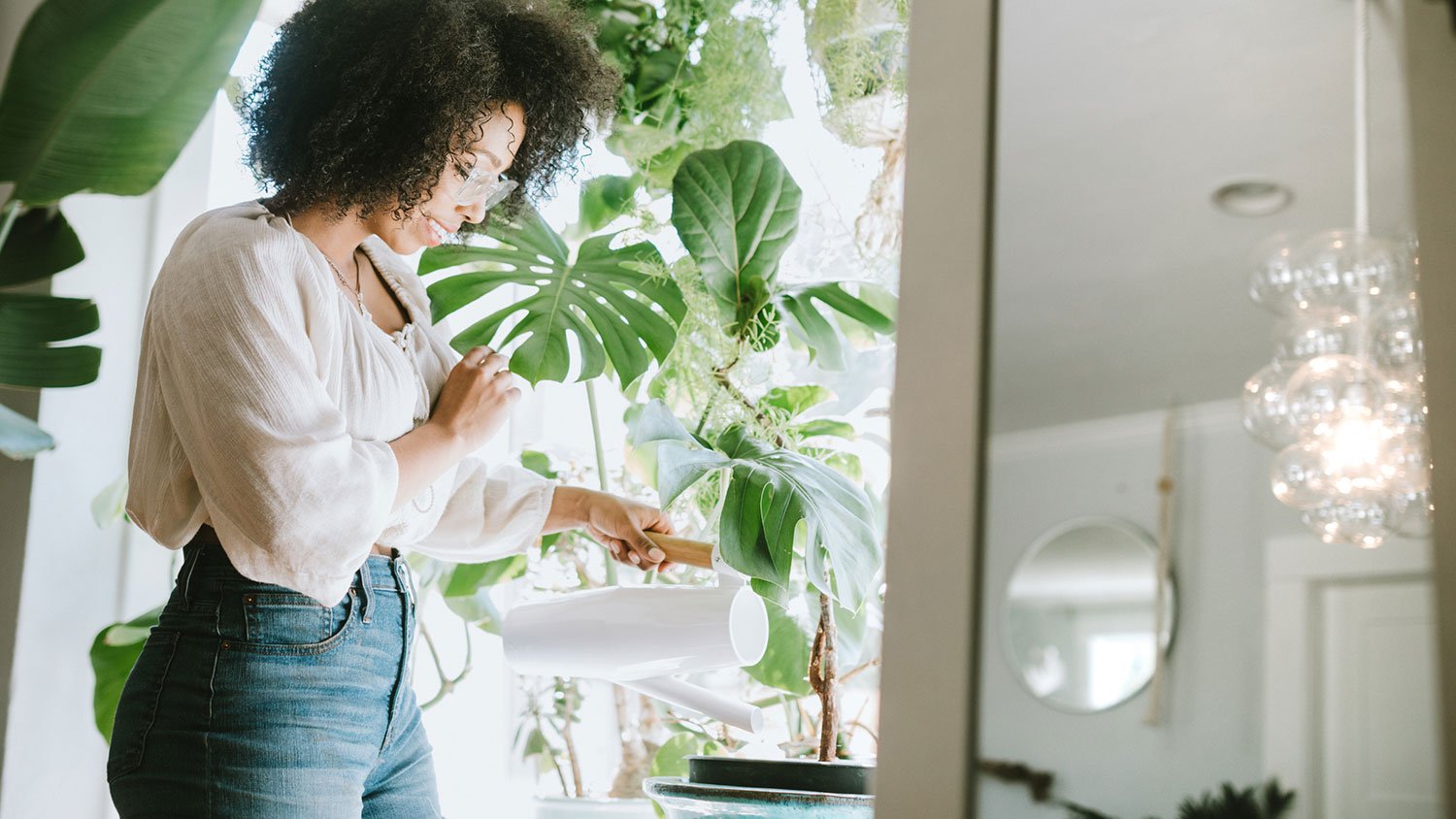 Woman enjoys watering the plants at home