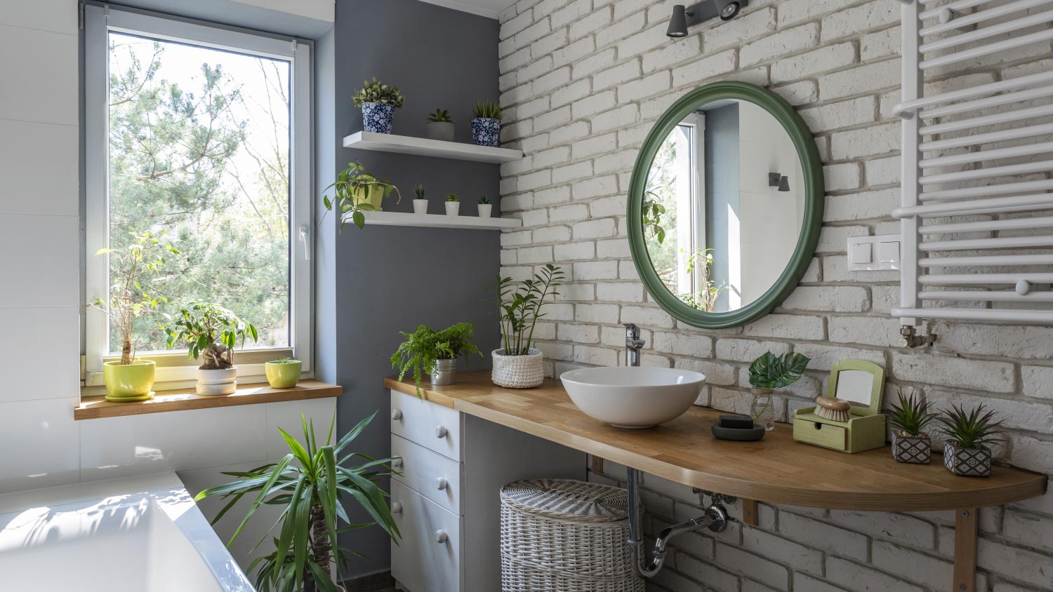 A white bathroom with green plants and wooden counter