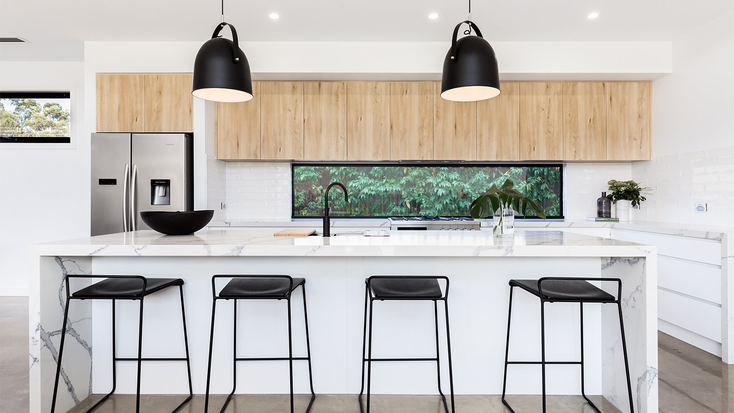 large white and black kitchen with marble island