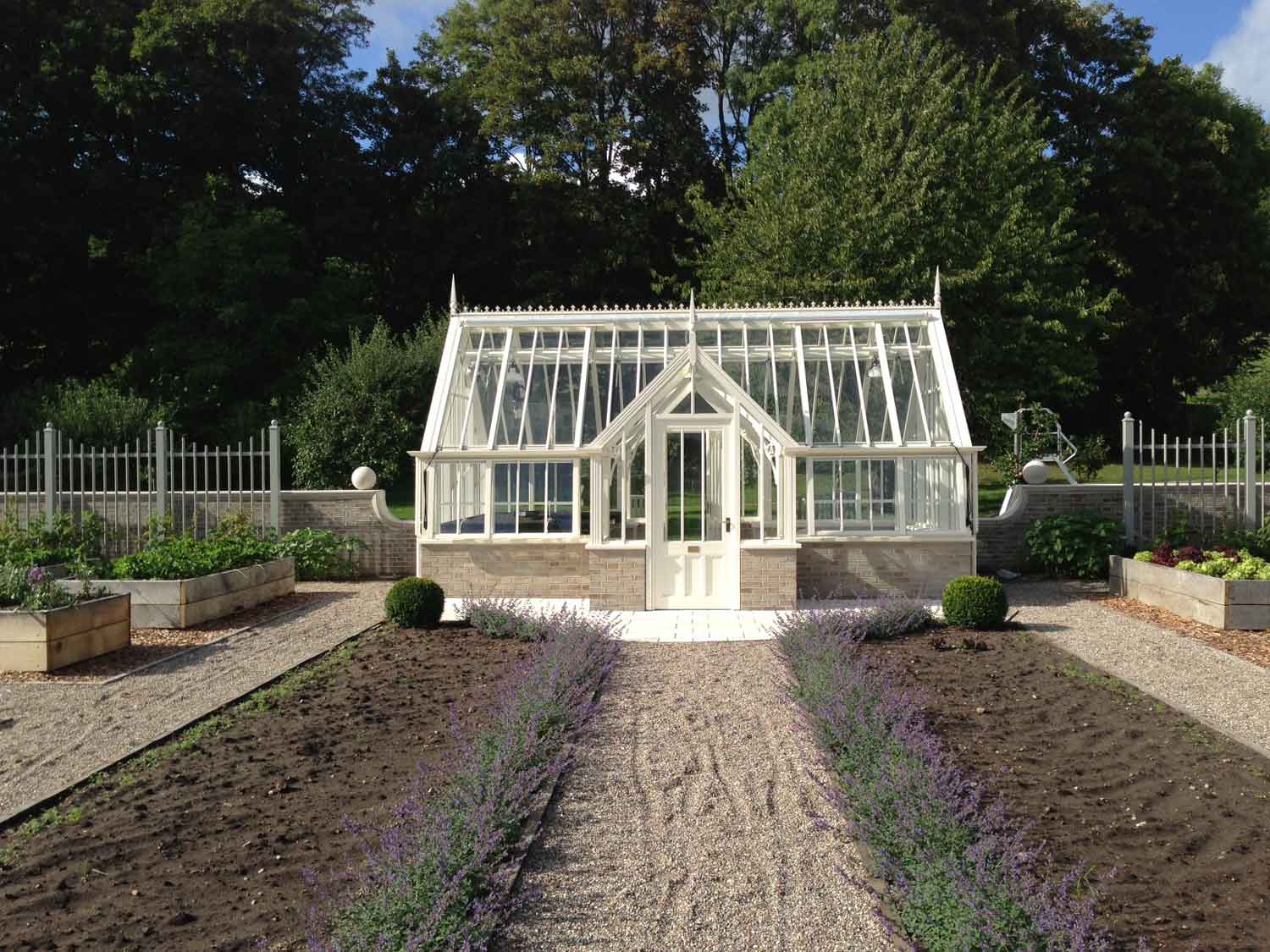 Backyard greenhouse with white frame