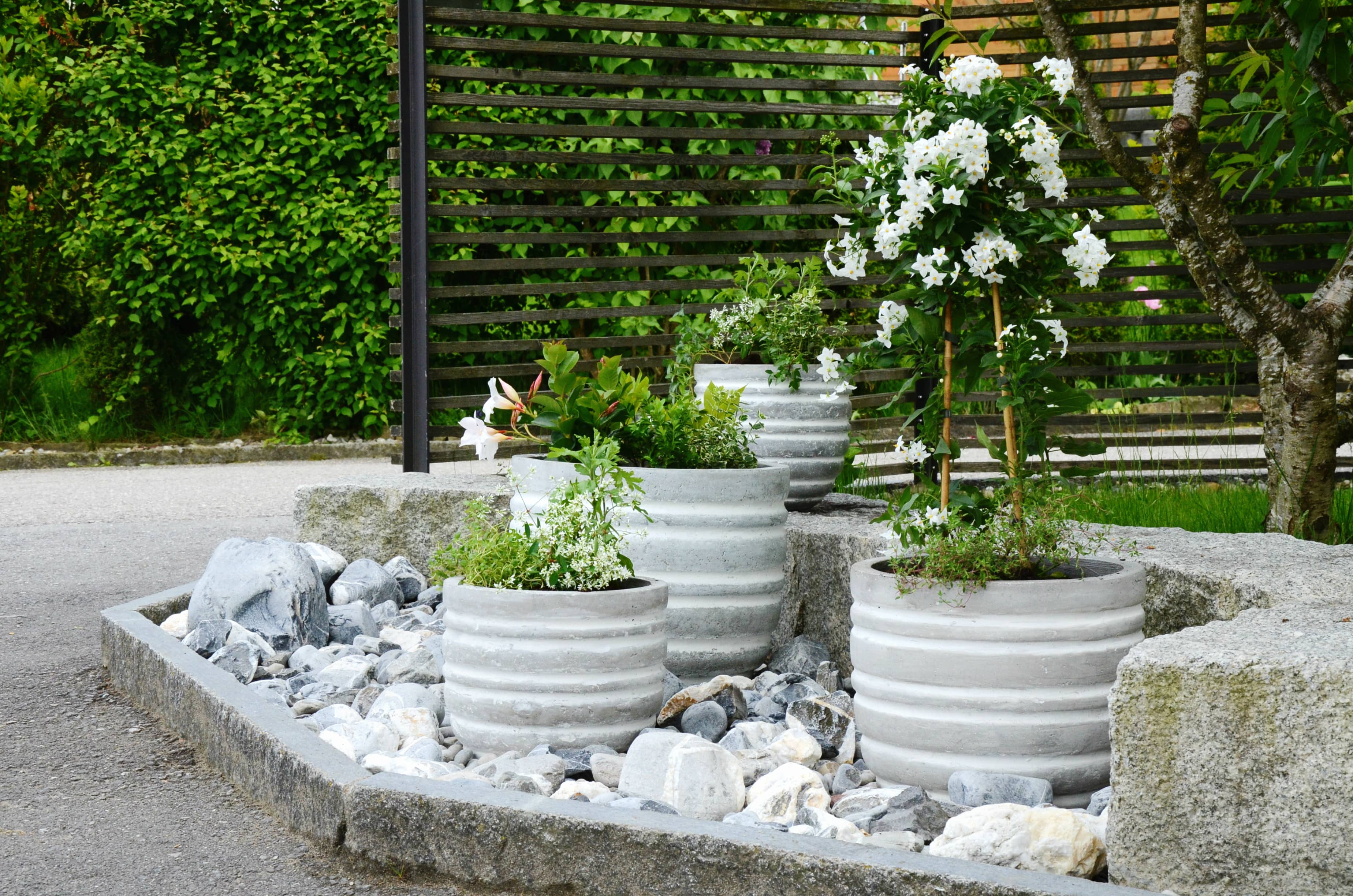 White rock garden with flower pots