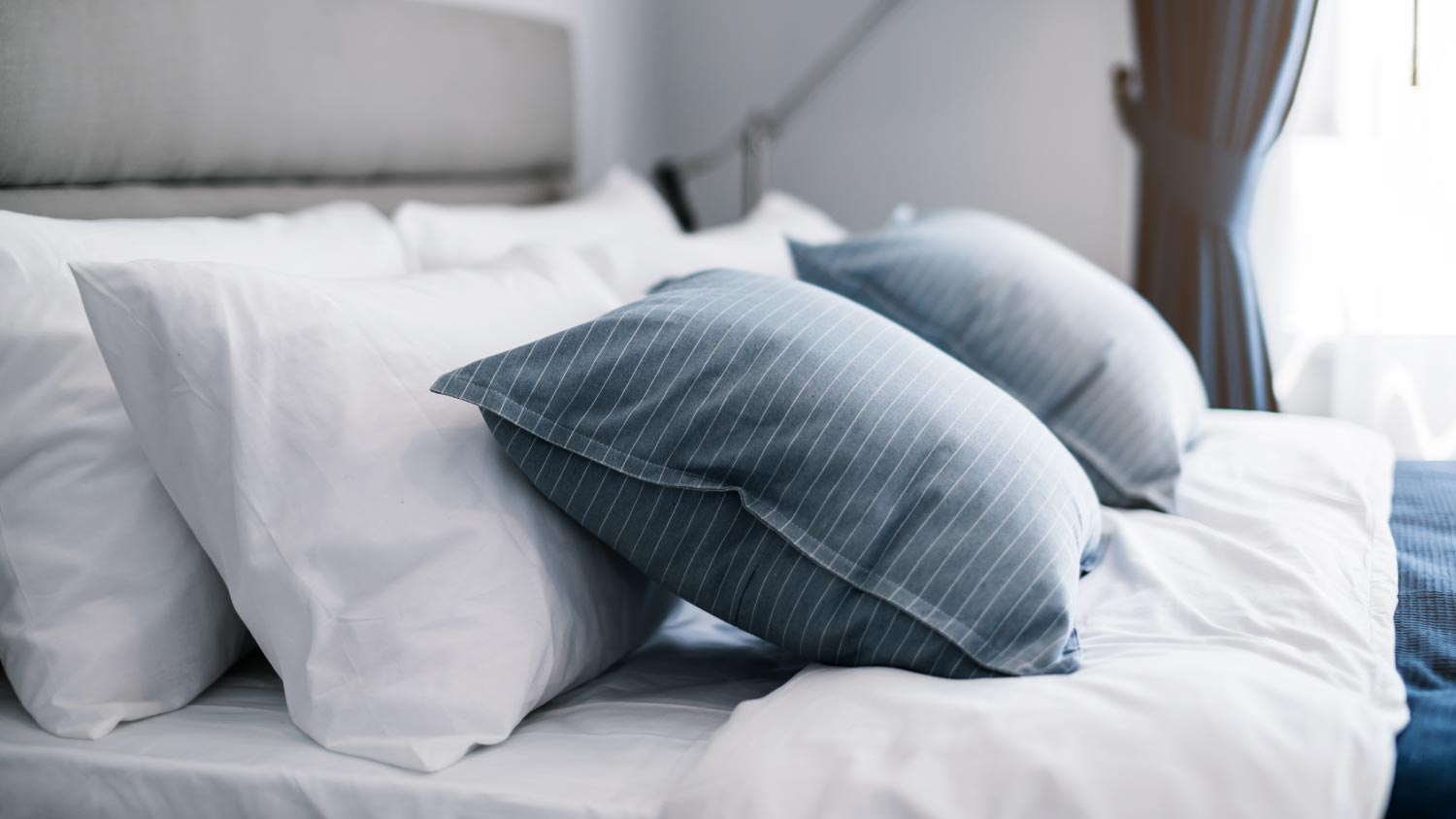 White pillows and bed sheets in beauty room