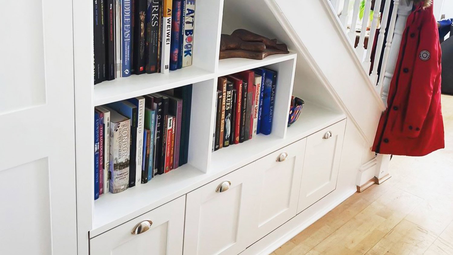 White stairs built in bookshelves drawers