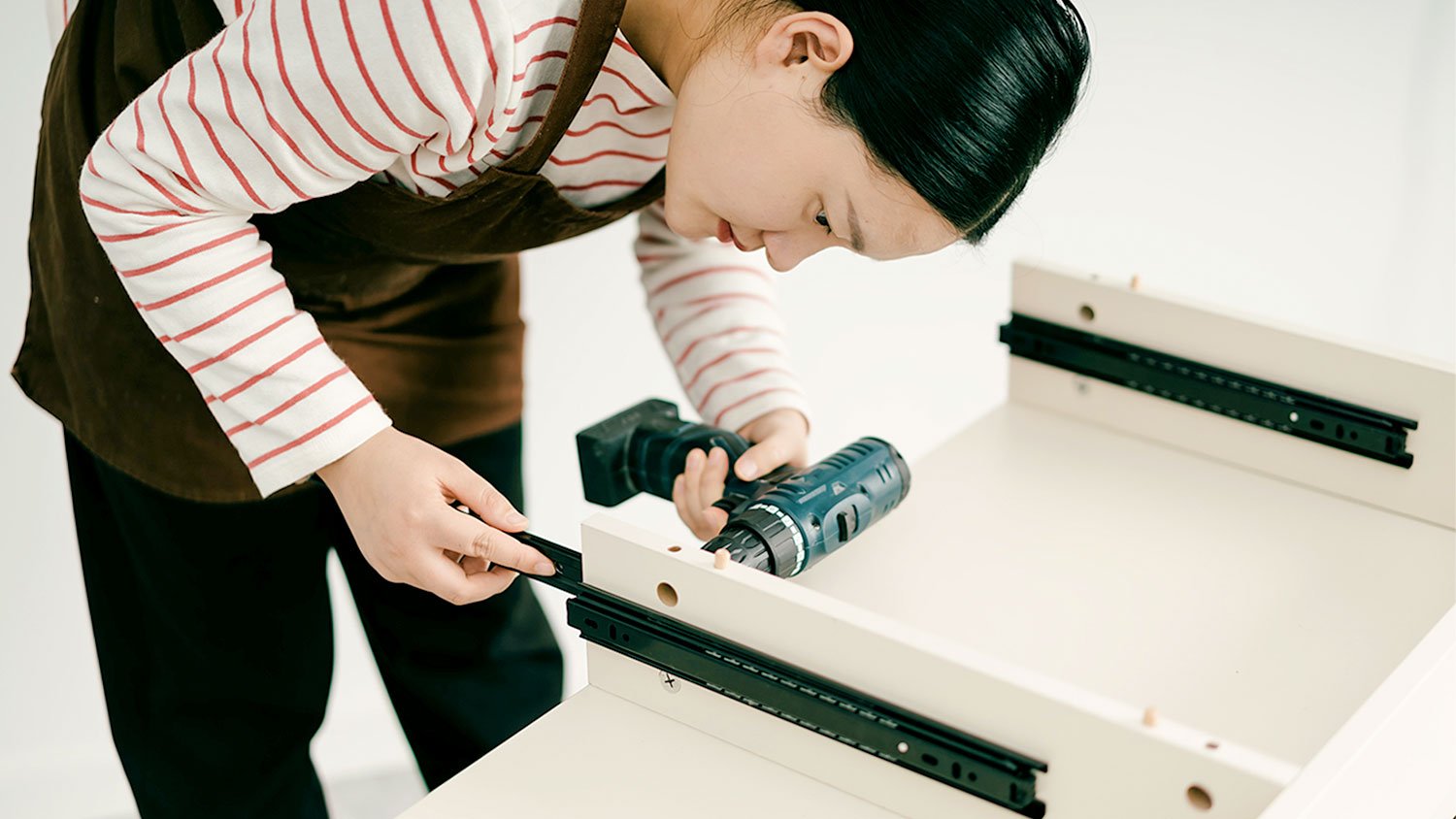 Woman building cabinets