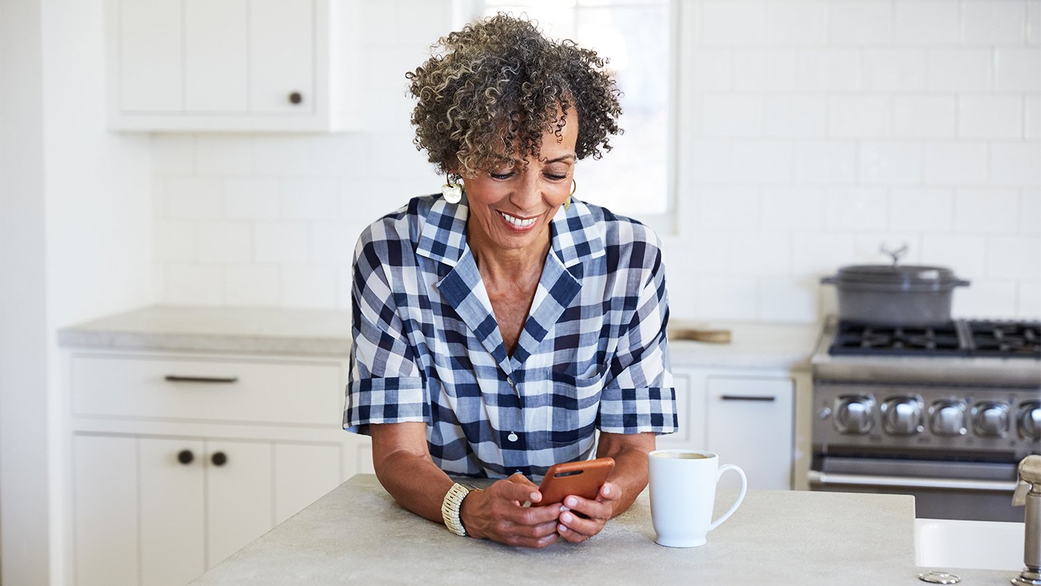 woman in the kitchen checking cell phone  