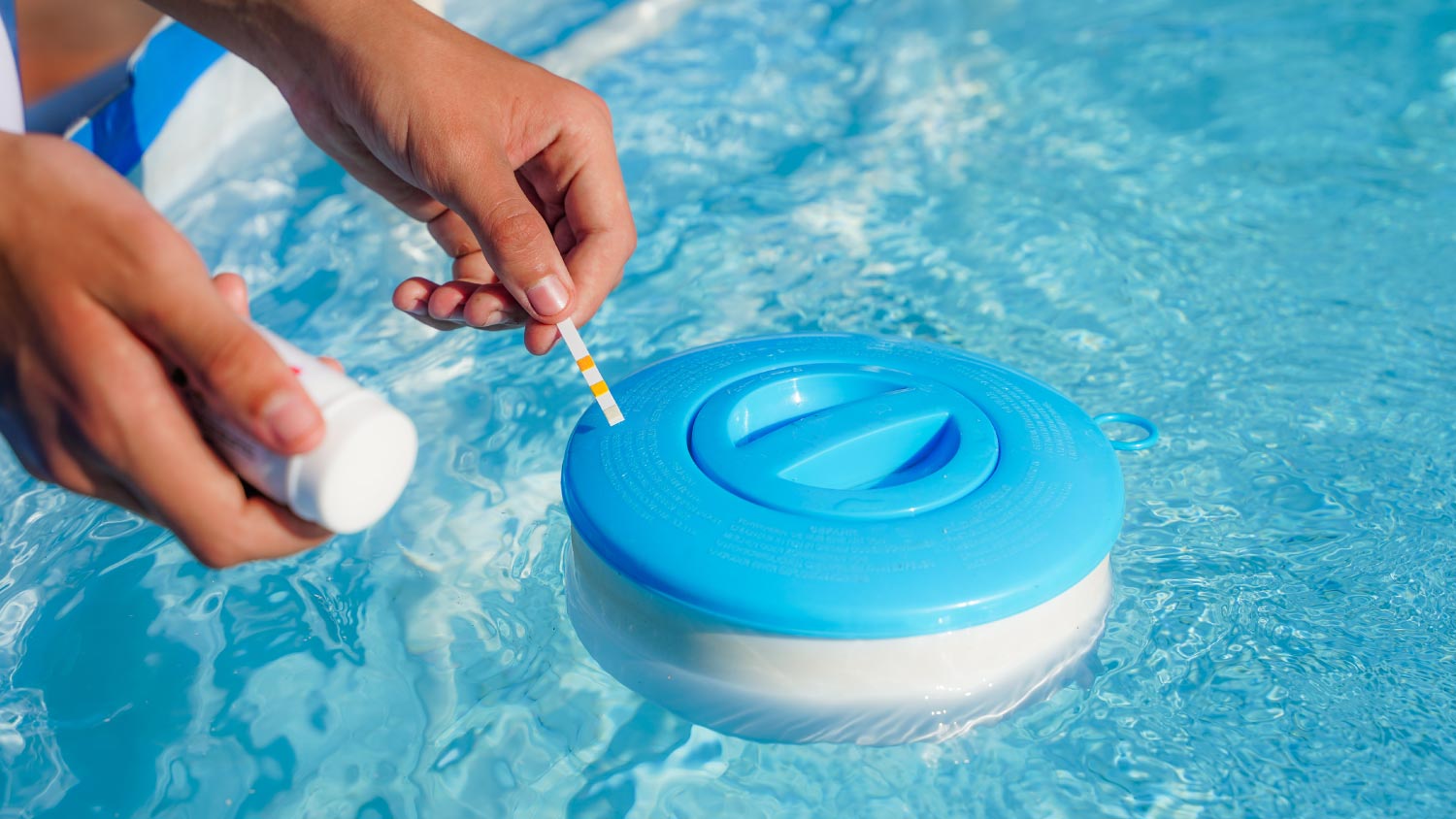 A woman checking the water quality of a pool