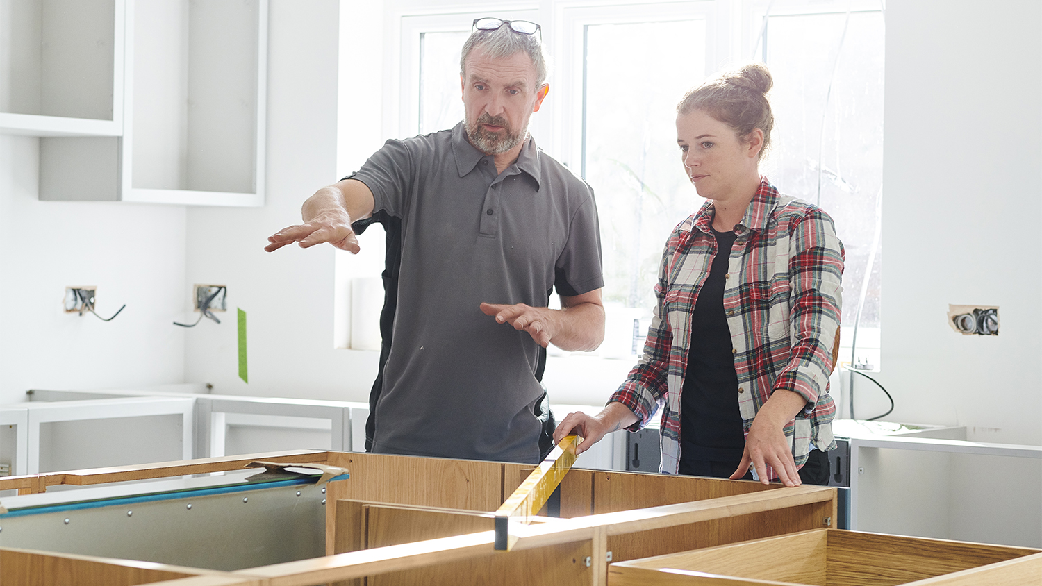 woman and contractor discussing kitchen remodel