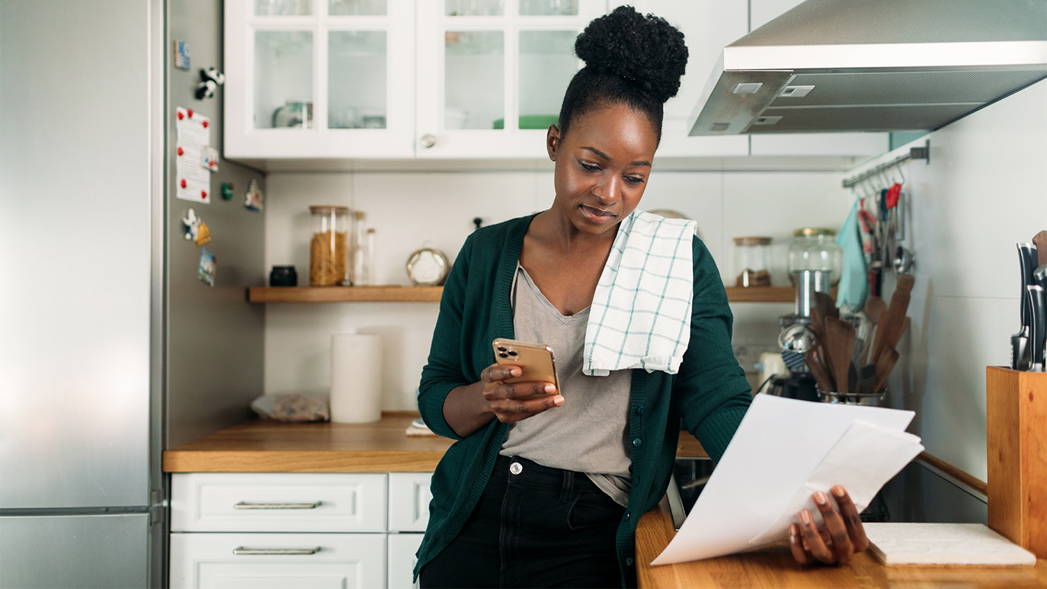 woman going over contracts in kitchen