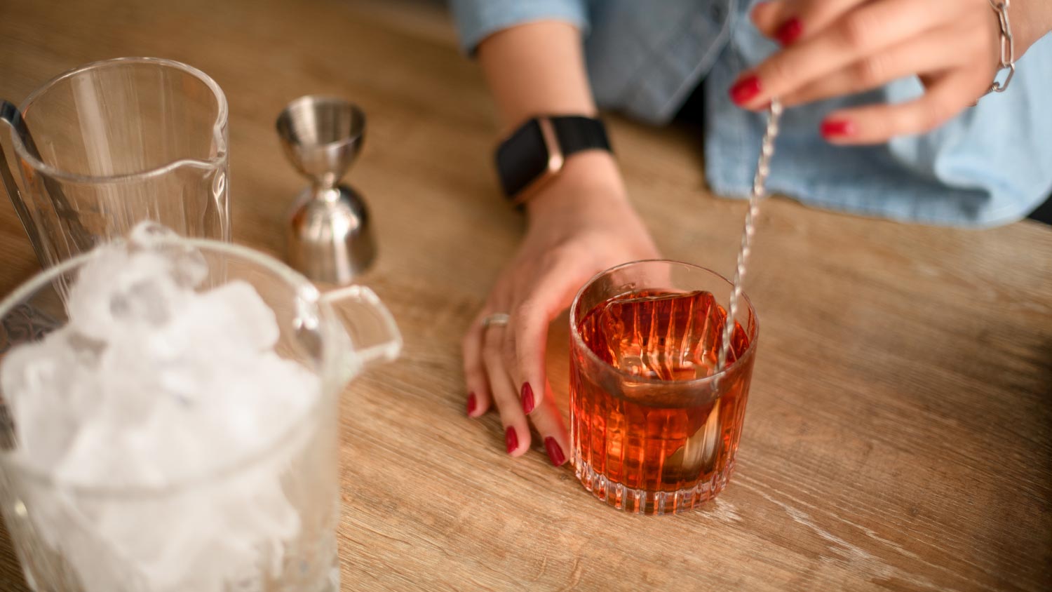 woman making a drink at a home bar