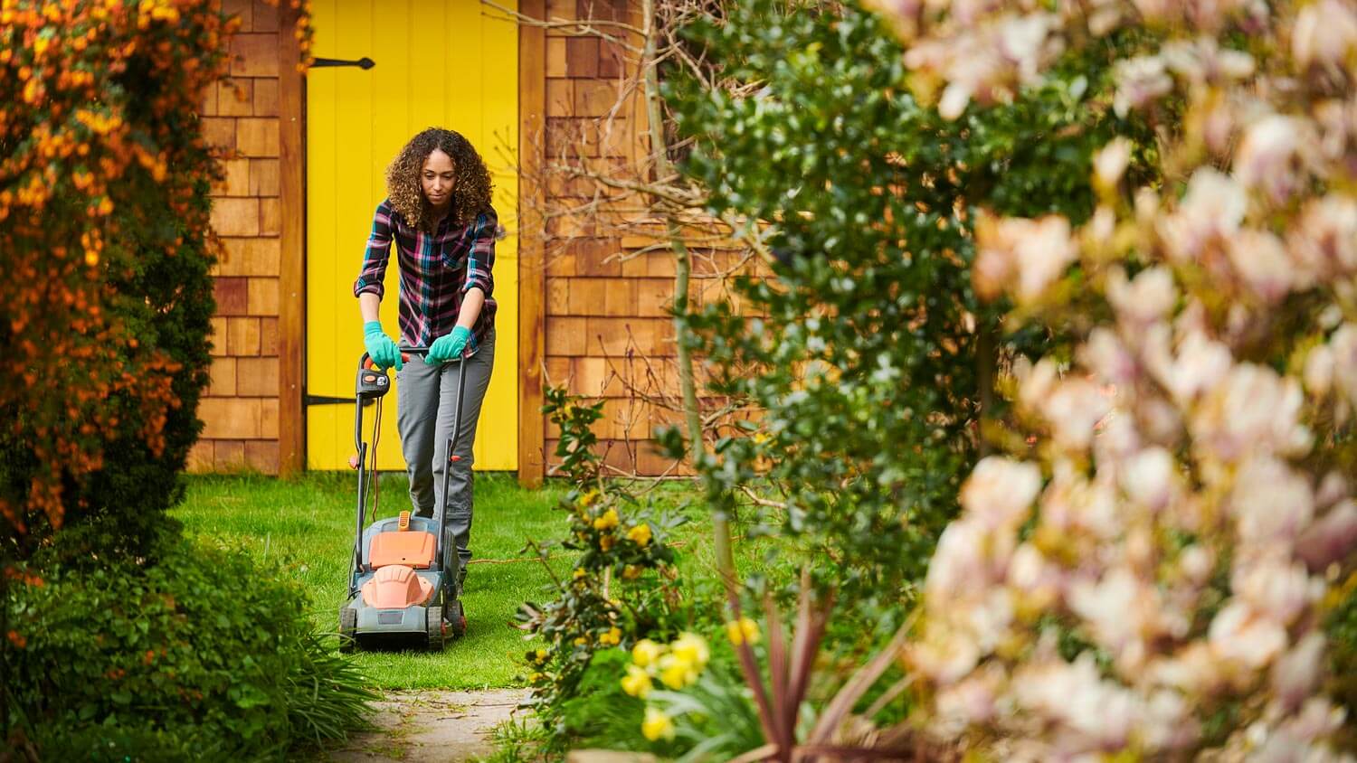 Woman mowing lawn