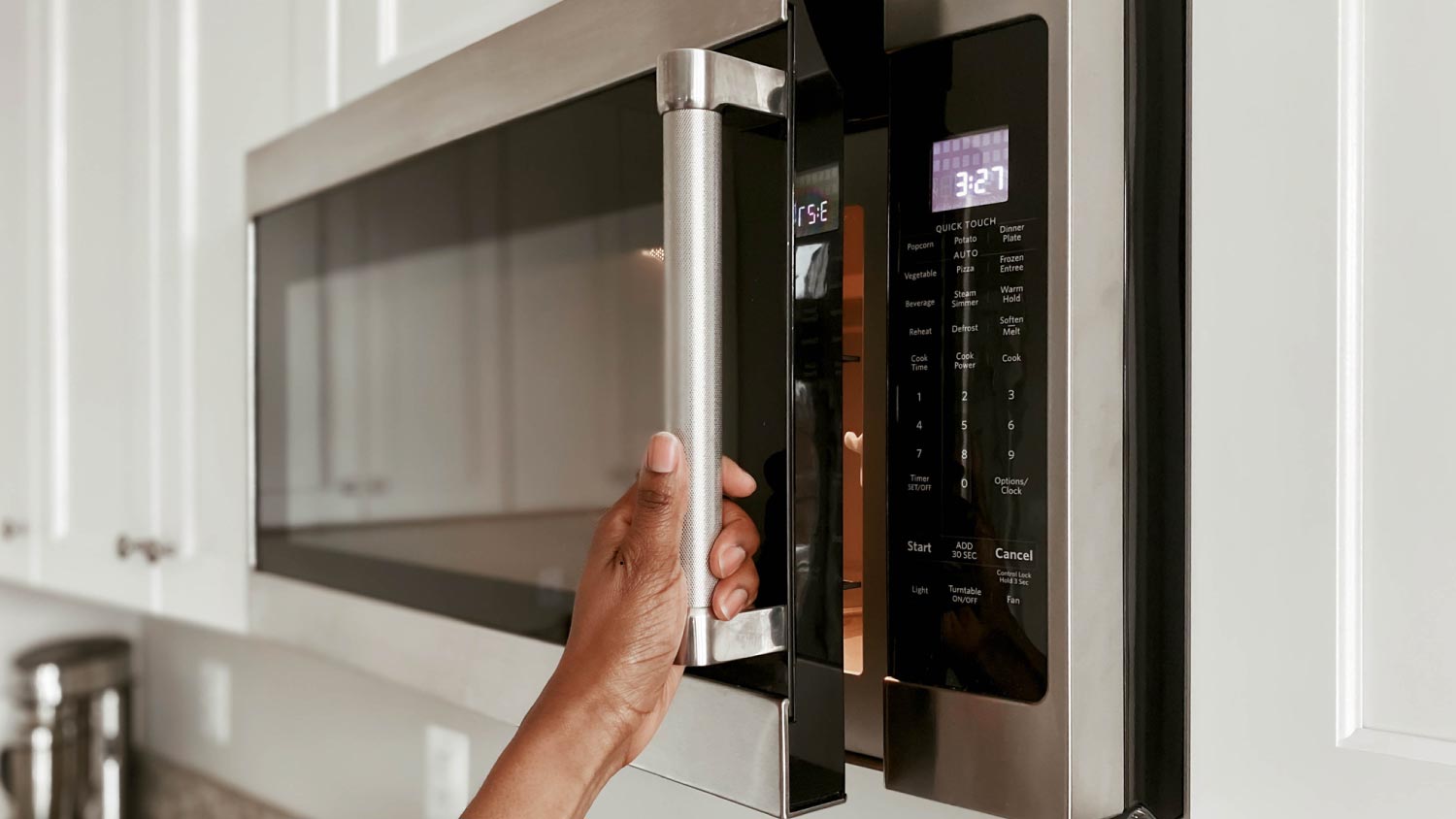 A woman opening microwave