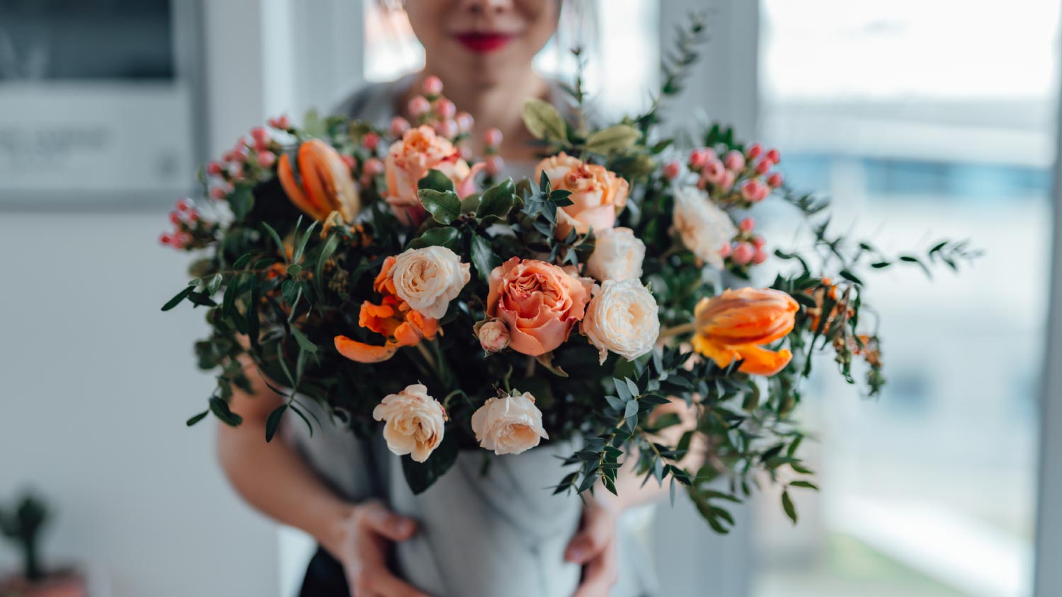 A woman receiving a flower bouquet