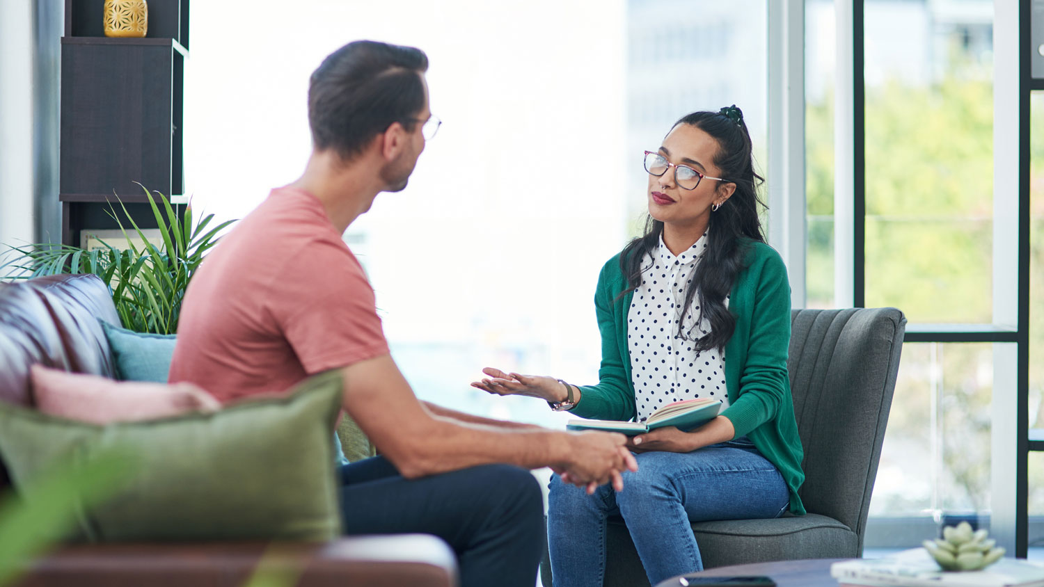 A woman interviewing an estate sale pro in her living room