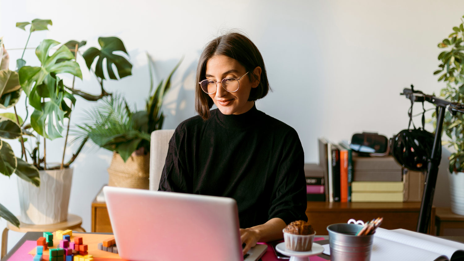 A woman using a laptop in her home