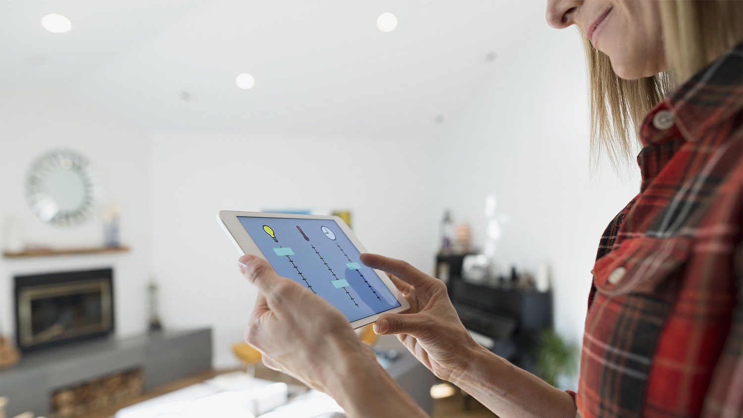 woman controlling home utilities using tablet