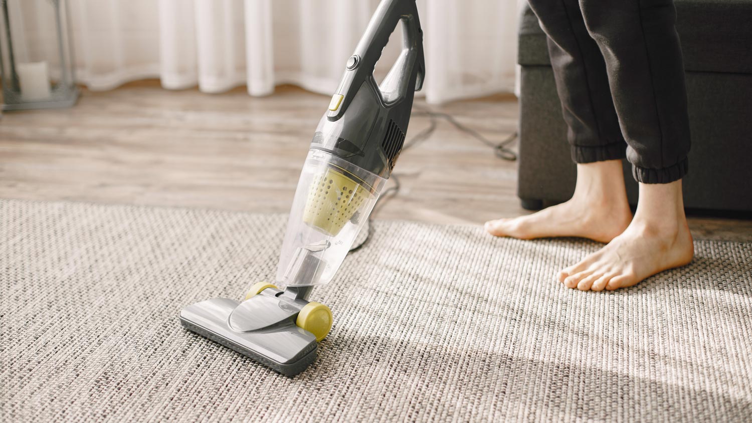 A woman vacuuming a carpet