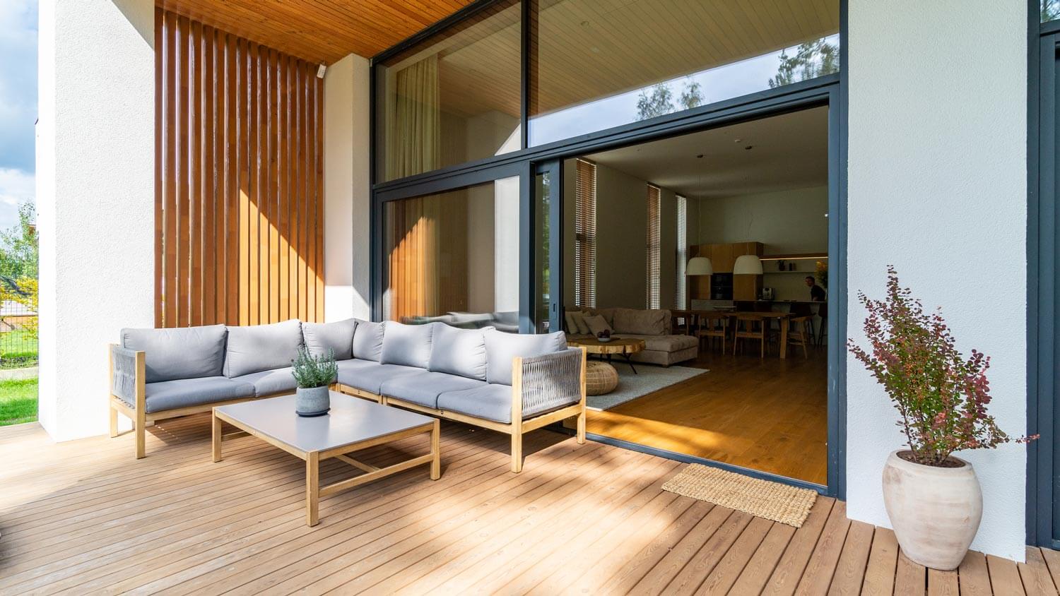 A wooden deck with an entrance to the house