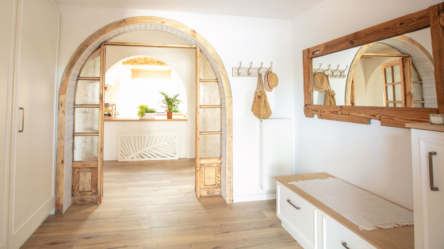 A large rectangular wooden frame mirror in the hallway