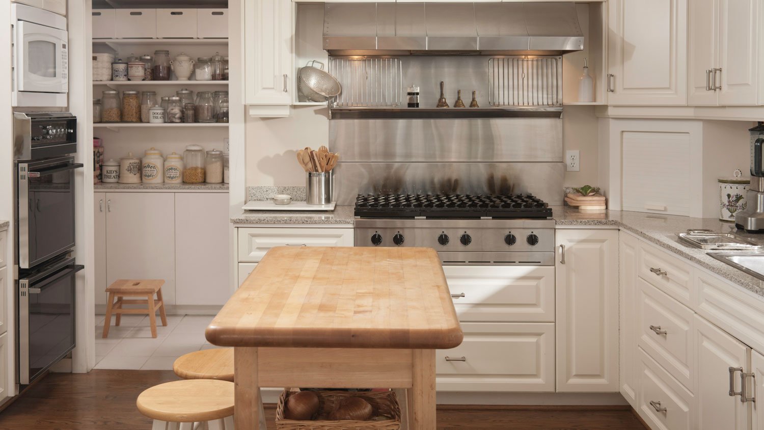 A wooden island in a fully equipped kitchen