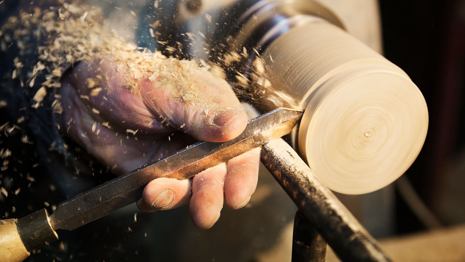 A carpenter working with wood in his workshop