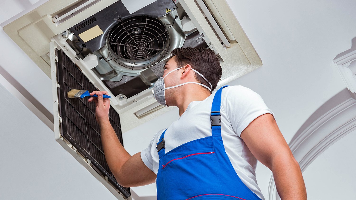 worker cleaning air ducts