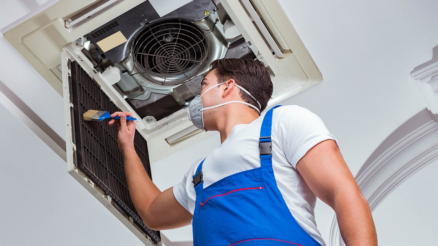 worker cleaning air ducts  