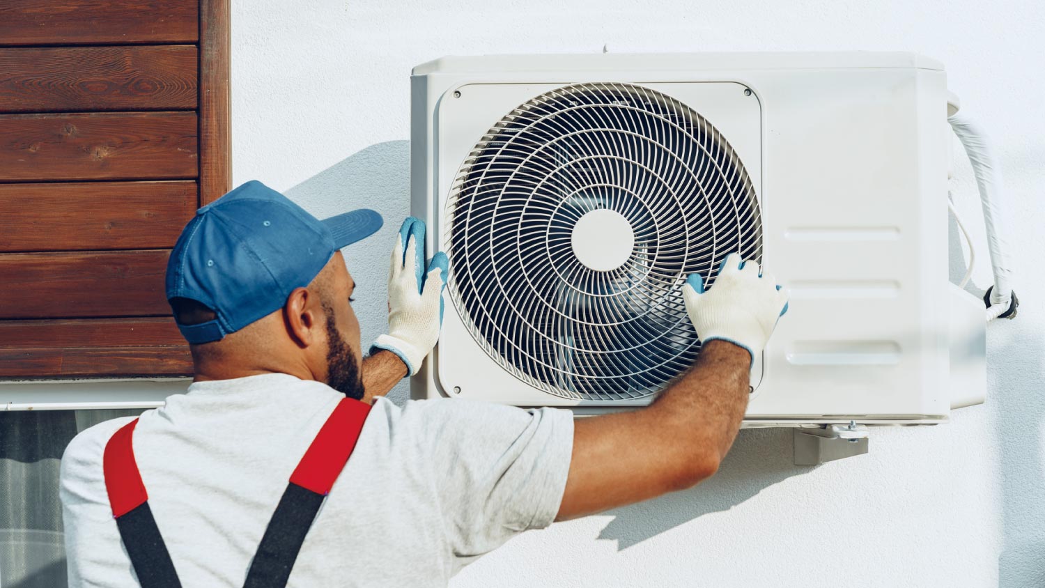 A worker installing the outside unit of air conditioner