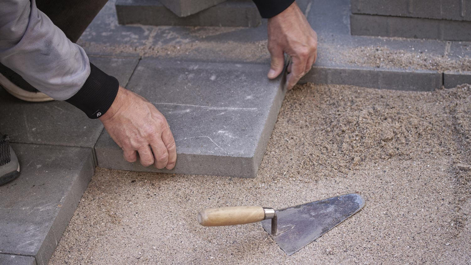 A worker laying pavers