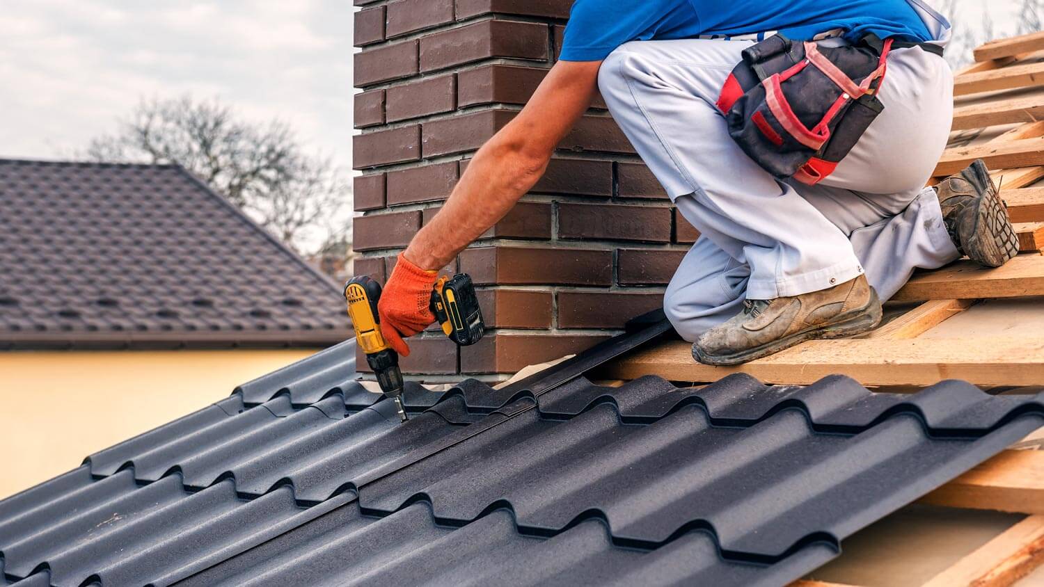 A worker repairing a roof