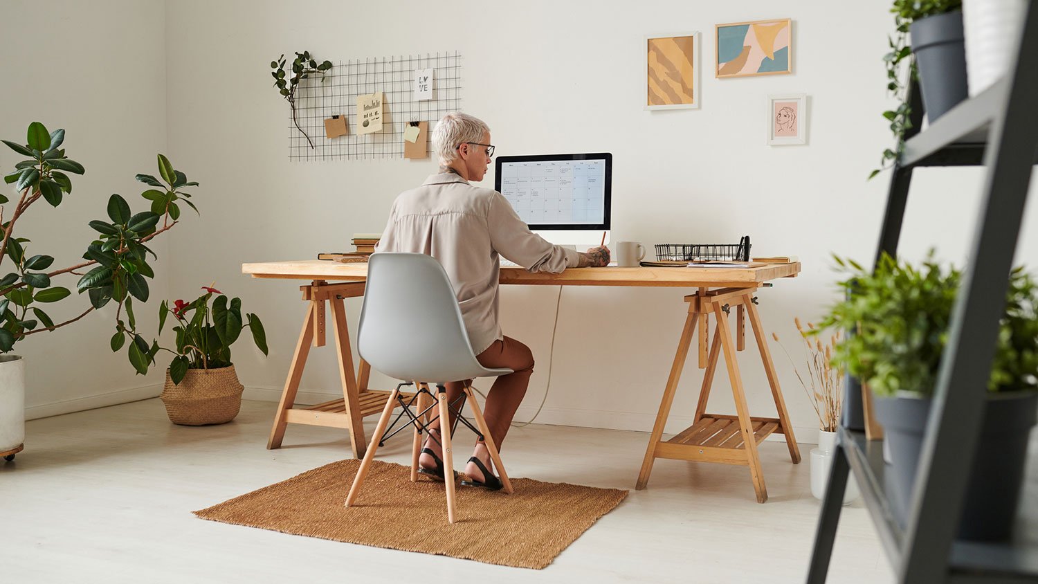businesswoman sitting at a desk working in her home office