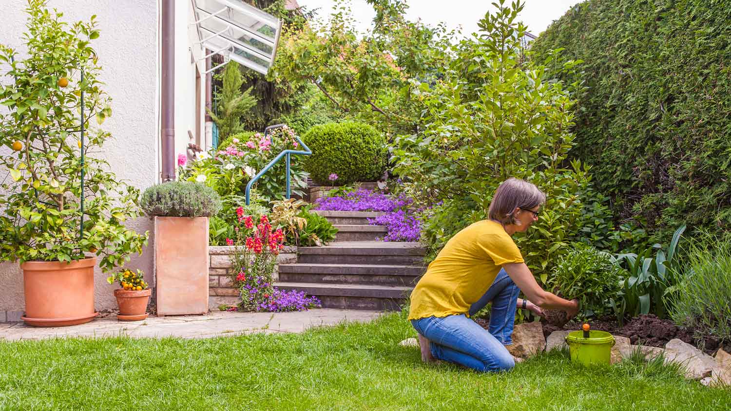 Woman planting new plants on her yard