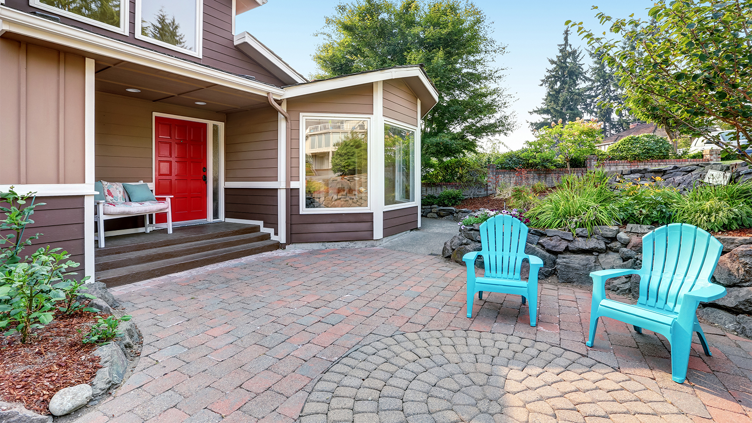blue chairs in yard on whorled paver